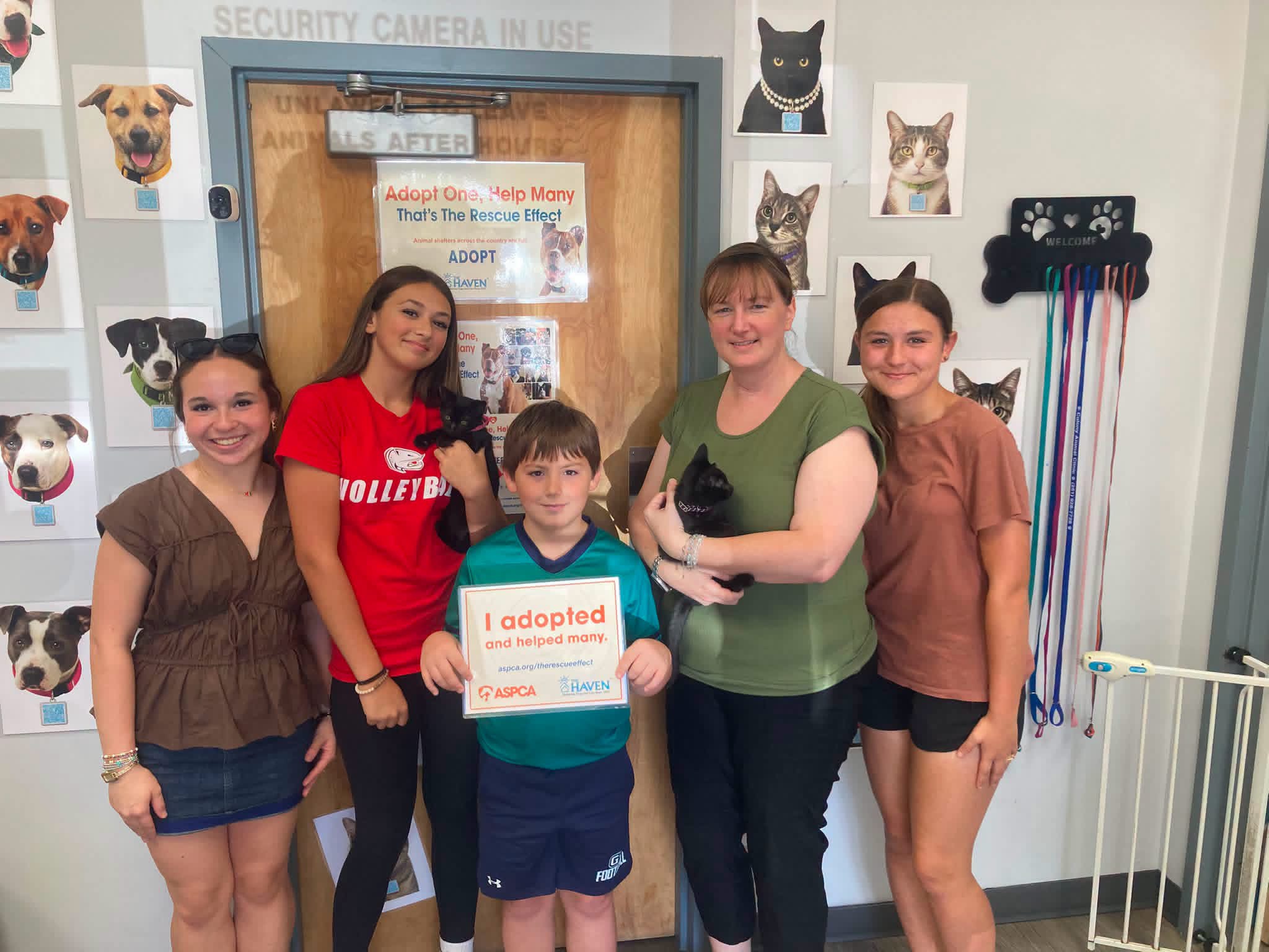 Adopters celebrating adoption day with their new pets at The Haven